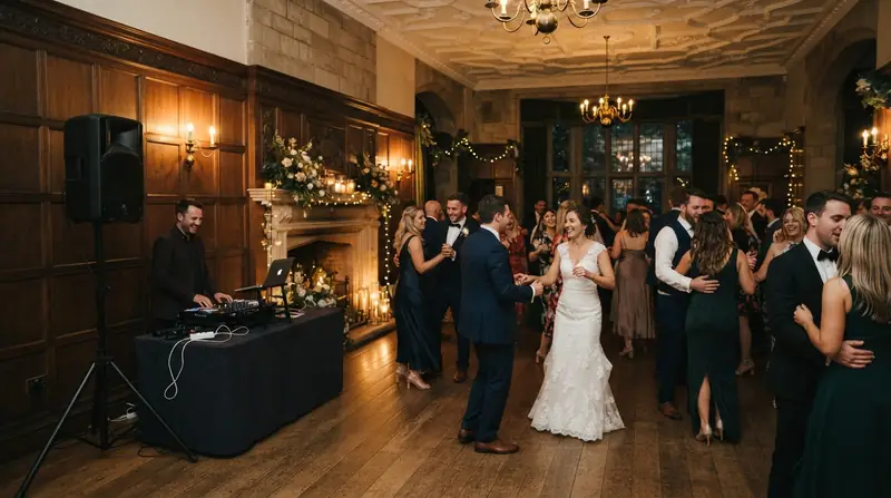 Guests dancing at a historic manor house wedding venue with a discreet speaker setup